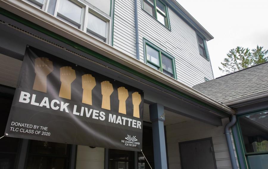 A banner hanging from a building reads Black Lives Matter
