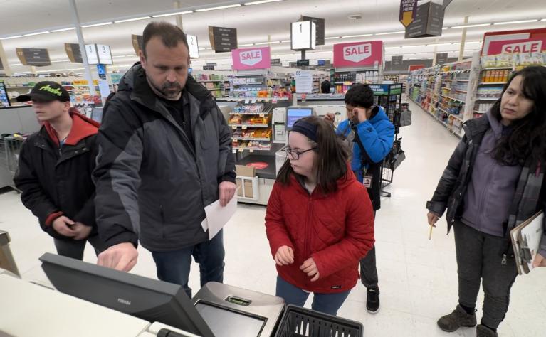 Students and teachers visiting a supermarket.