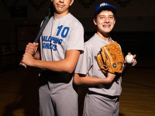 Two MPS athletes posing with baseball bat and ball. 