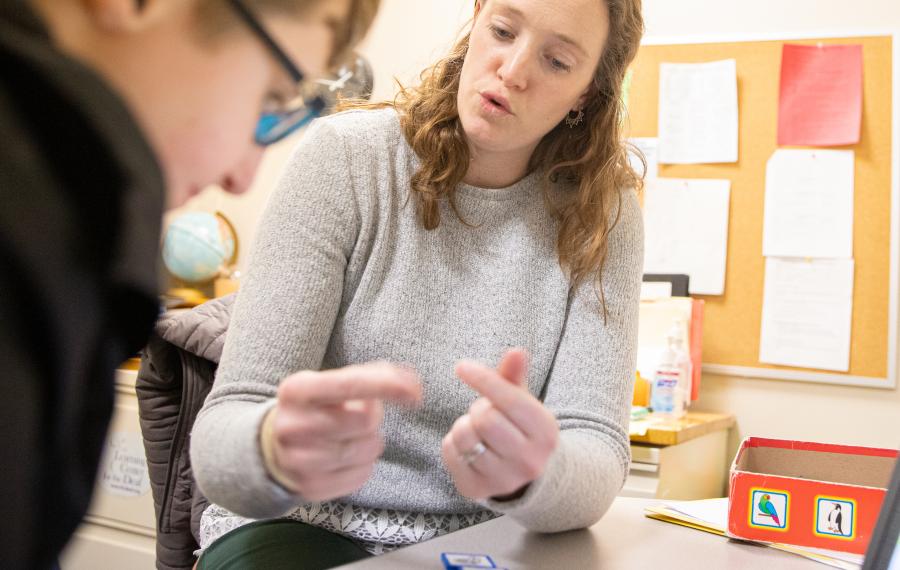 teacher signing to a student. 