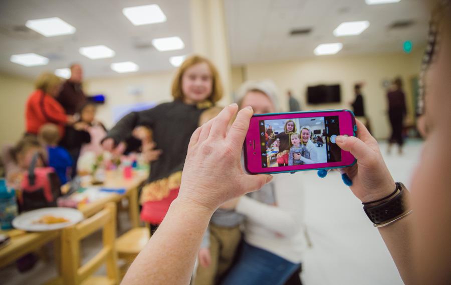 A staff taking picture of family 