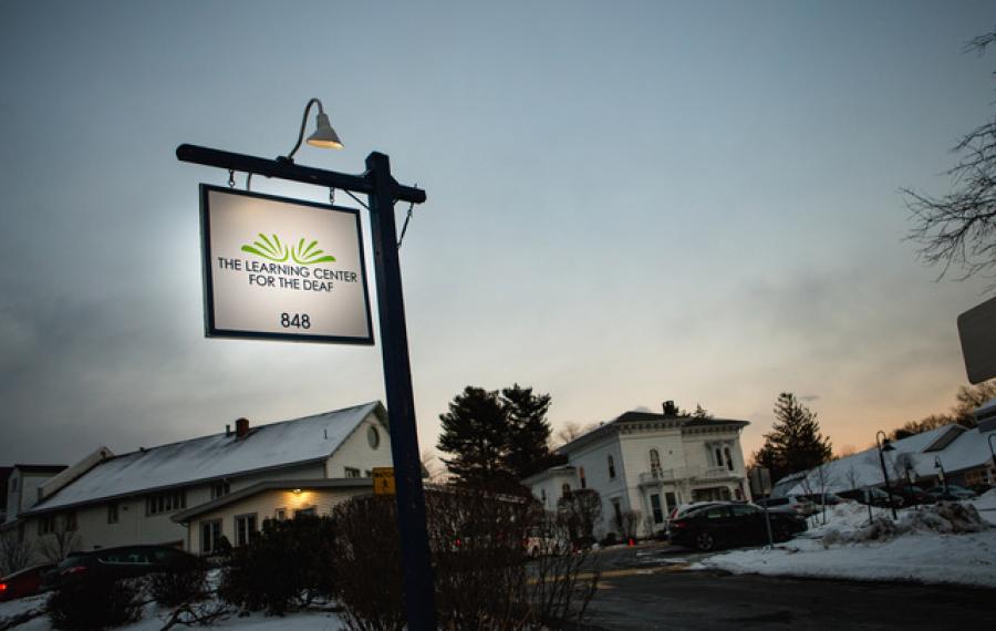 TLC campus sign at sunset.