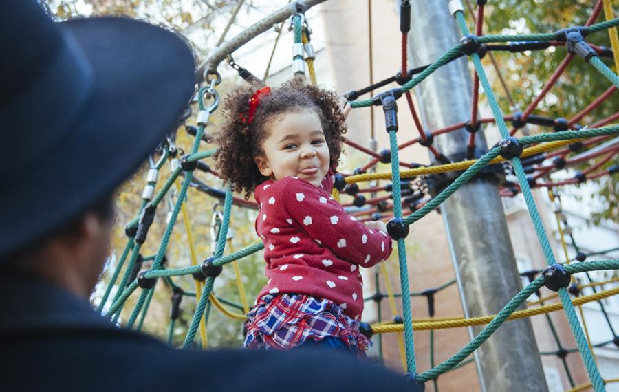 Toddler on playground equipment