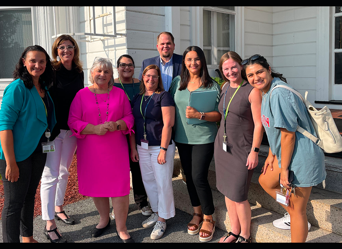 A group of TLC staff with members of the Commission on the Status of Persons with Disabilities