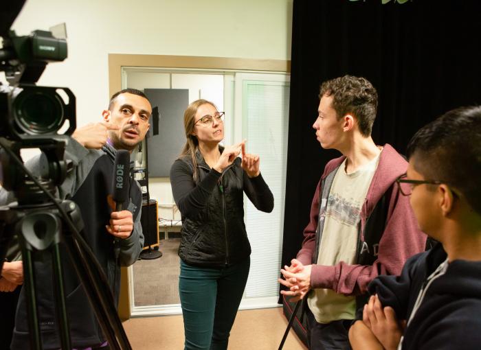 Interpreting group of students with video camera
