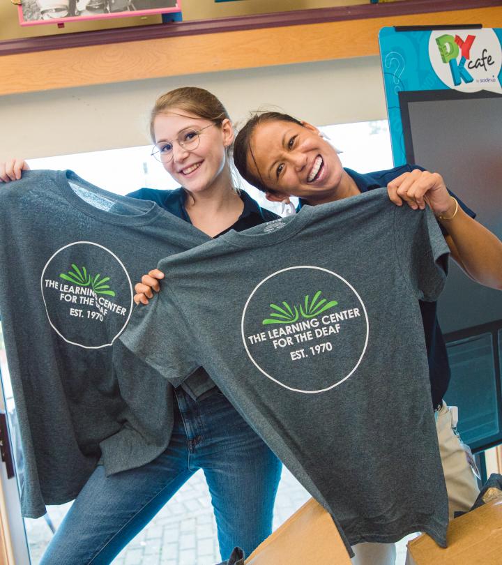 Two TLC staff smiling with TLC shirts