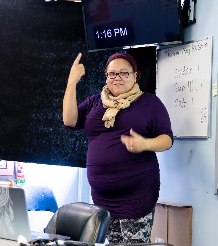 A teacher talking to students in the classroom.