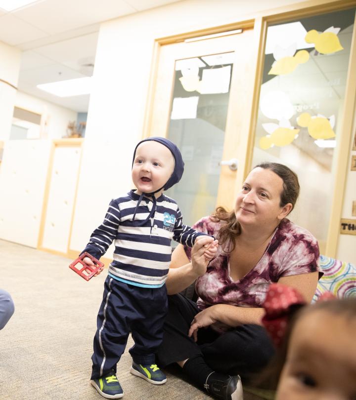 A mother and toddler listening to teacher.