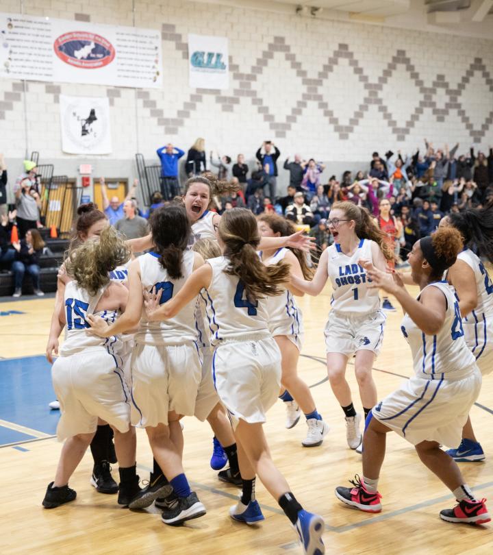 Lady Ghost huddling during basketball game.
