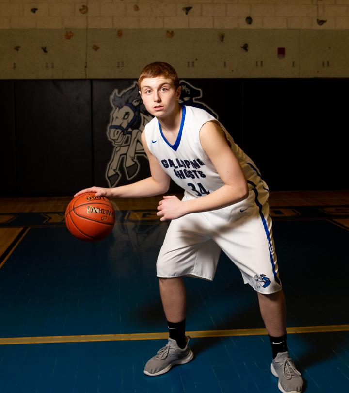 MPS basketball player dribbling basketball ball.