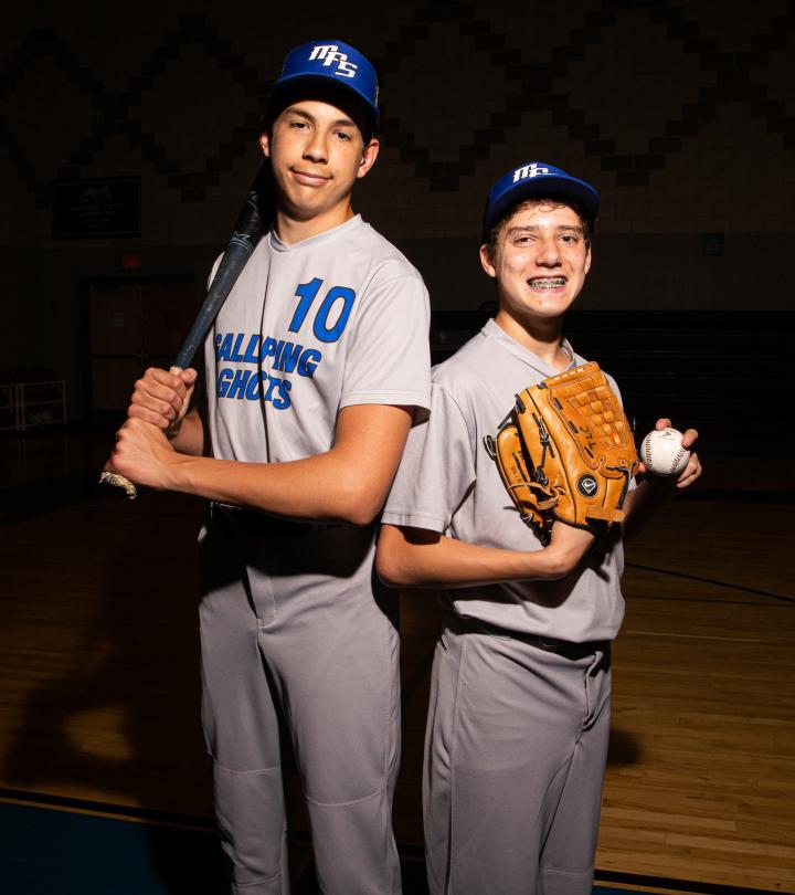 Two MPS athletes posing with baseball bat and ball.