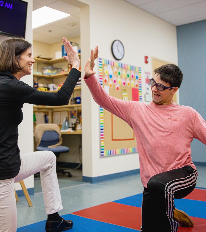 Student giving a high five to therapist.