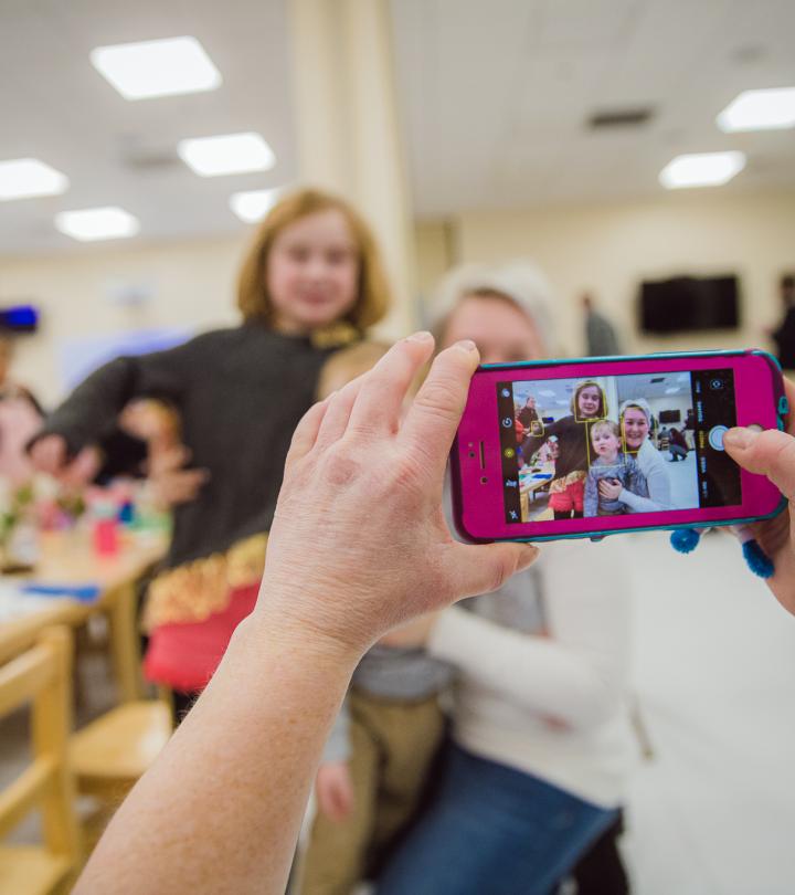 A staff taking picture of family