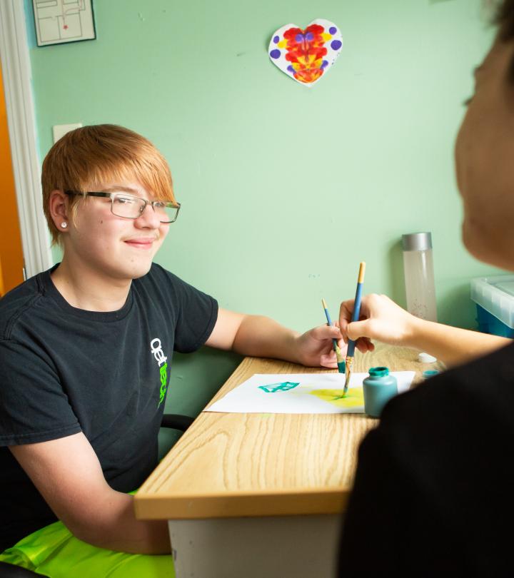 A student smiling at therapist.