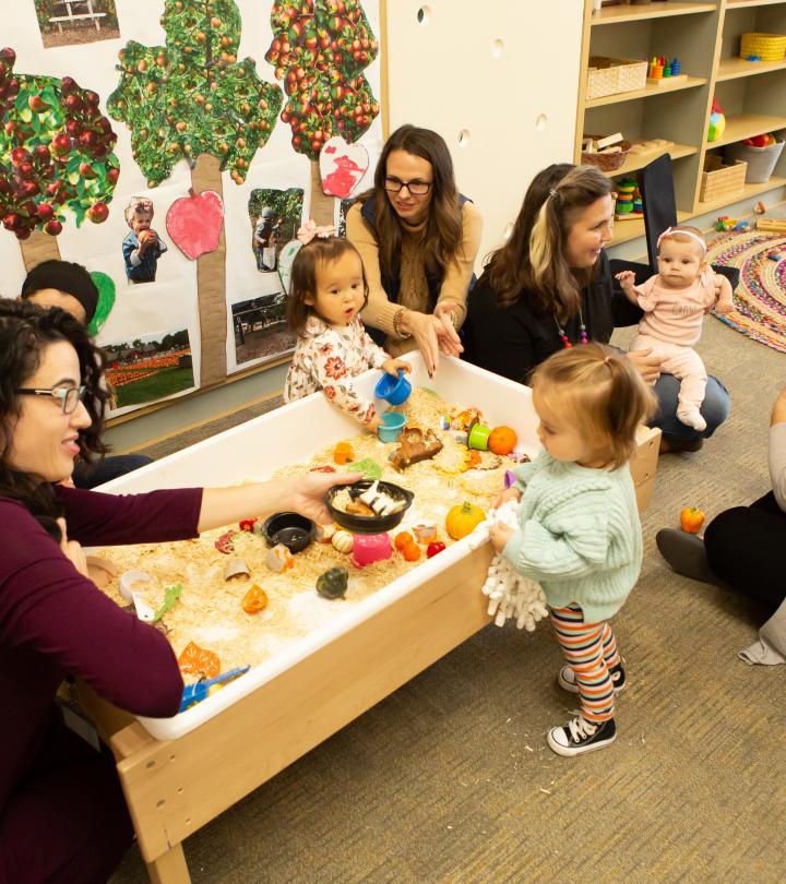 Parents, teachers, and children chatting in the classroom.