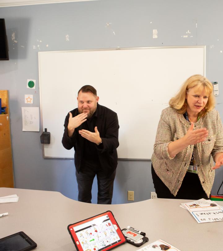 ASL interpreter interpreting a teacher in classroom. 