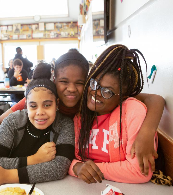 Group picture of three students at cafe.