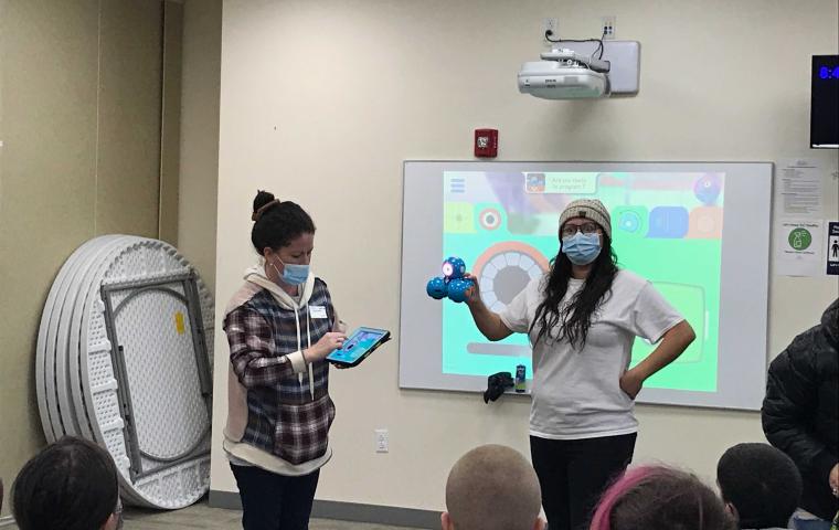 Two presenters at the front of a room.