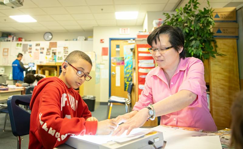 Teacher working with a student in the classroom. 