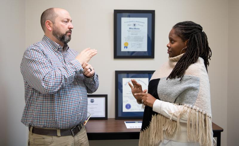 WCS staff talking one on one. 