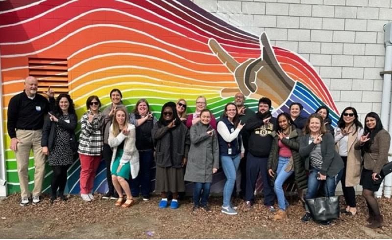 MetroWest Leadership Academy stands in front of the TLC Rainbow Mural