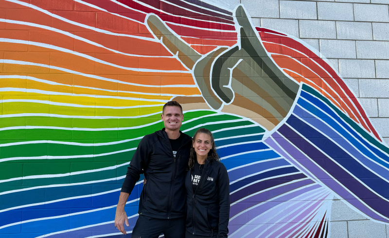 Scott Lehmann and Shayna Unger in front of the TLC Mural.