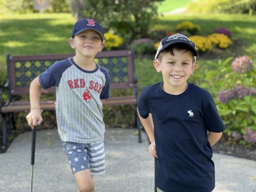 Two young boys smiling at the camera.