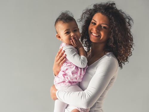 Young woman holding a baby