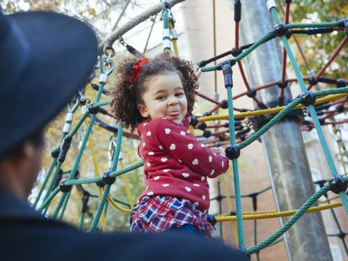 Toddler on playground equipment