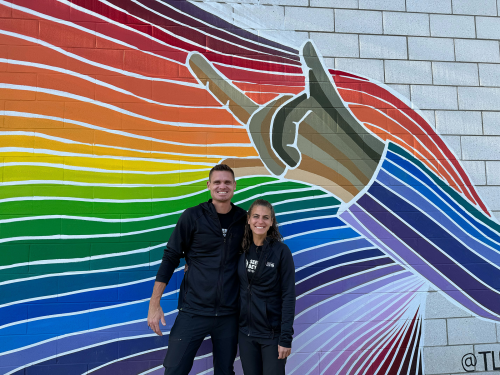 Scott Lehmann and Shayna Unger in front of the TLC Mural.